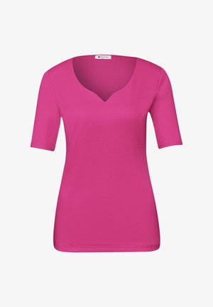 Kirkkaan pinkki lyhythihainen paita, jossa on hienovarainen V-muotoinen uurre pääntiessä, istuva leikkaus ja sileä tekstuuri.