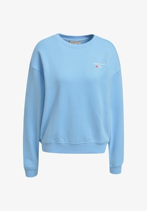 Light blue crewneck sweatshirt with long sleeves and ribbed cuffs, hem, and white text near left chest reading "Ticket to your story" with a red heart.
