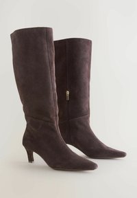 Knee-high, dark brown suede boots with a pointed toe and a slim heel. Features a side zipper for closure and a smooth texture.