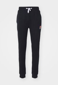 Svarta avsmalnande sweatpants med elastisk midja och vit dragsko, med en liten orange och vit Ellesse-logotyp på vänstra låret.