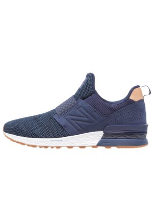 Granatowy sportowy tenisówka wsuwana z siateczkową cholewką, białą teksturowaną podeszwą, amortyzowanym piętą i pętelką z tyłu.