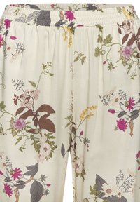 Floral-patterned lightweight fabric pants featuring an elastic waistband, with a cream background and multicolored botanical designs.