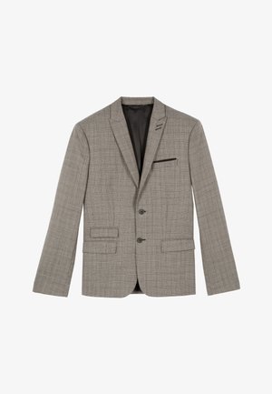 Blazer à carreaux gris avec revers en pointe, fermeture à deux boutons et poches latérales. Doublure intérieure avec une poche poitrine ornée d'un accent noir.