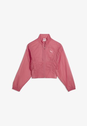 Chaqueta corta rosa Puma tipo cortavientos con cremallera completa frontal, puños elásticos y logotipo blanco de Puma en el pecho.