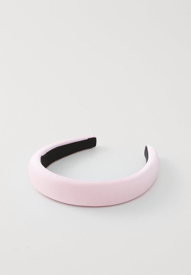 Růžový saténový pásek s hladkým povrchem, který má černý sametový interiér pro pohodlí a zaoblený, jednoduchý design.