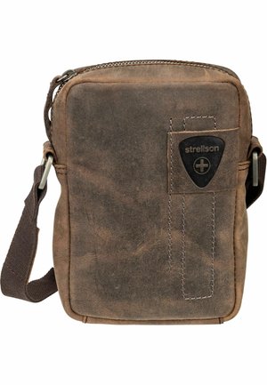 Brown leather shoulder bag with a zip closure, featuring a front pocket, white stitching details, and an adjustable fabric strap.