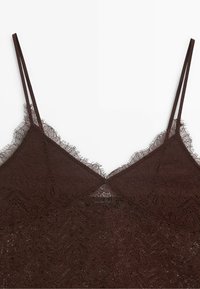 Dark brown lace camisole with thin double shoulder straps and scalloped lace edges along the neckline and upper chest.