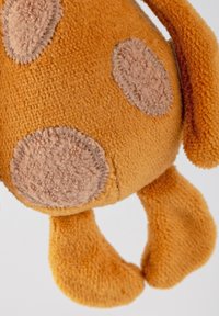 Plush toy in orange fabric with brown fleece spots, floppy ears, and flat, rounded paws. Soft texture, round body shape, approximately 30 cm tall.