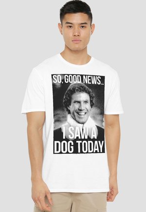 Man wearing white t-shirt with black and white graphic of smiling man and text "So, good news... I saw a dog today."