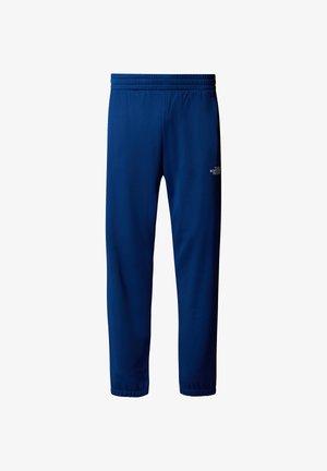 Marineblaue Sporthosen aus weichem Stoff. Mit einem elastischen Bund, der aus mehreren Nähten besteht, und einem kleinen weißen Logo an der Seite.