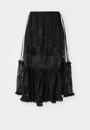 Black lace skirt with a ruffled hem, featuring transparent fabric and white ribbon accents at the sides. Softer texture with floral patterns.