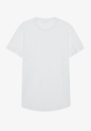 Vit t-shirt med kort ärm i mjuk bomull. Rund hals, rak skärning, lätt tyg och sömlös design utan tryck eller accenter.