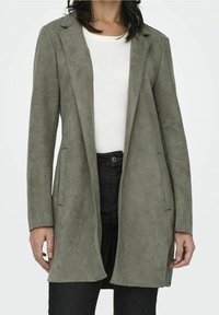 Langer, offen frontaler Mantel aus olivgrünem, wildlederähnlichem Material. Verfügt über Reverskragen mit Kerbung, Seitentaschen und eine schlanke Silhouette.