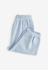 Pantaloni in cotone waffle di colore azzurro chiaro, con cintura elastica, morbida texture e vestibilità rilassata, ripiegati ordinatamente su uno sfondo bianco.