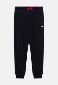 Pantaloni della tuta navy con vita elasticizzata, cordino rosso e polsini elasticizzati. Presenta un piccolo logo bianco e rosso sulla gamba sinistra.