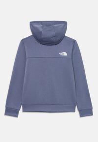 Felpa con cappuccio in morbido tessuto blu opaco. Caratterizzata da un design monocolore con un logo bianco sulla parte superiore della schiena e polsini a coste.