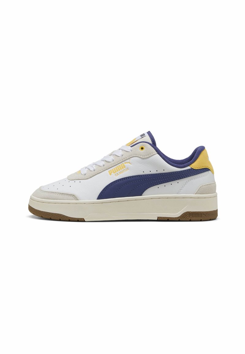 Puma CA Match sneakers feature a white leather upper with blue and yellow accents, a textured beige sole, and punctured detailing on the sides.