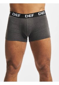 Dark gray boxer briefs made of soft fabric, featuring a black elastic waistband with "DEF" written in white, short leg length.