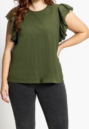 Olive green short-sleeve top with layered eyelet ruffle sleeves. Soft material with a relaxed fit, complemented by a rounded neckline.