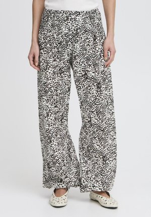 Pantaloni leggeri e svasati in un motivo astratto bianco e nero. Presentano una vita elasticizzata e una texture liscia.