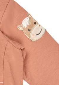 Long-sleeve shirt in soft pink fabric featuring a brown horse face embroidered on the elbow, with white and black accents.