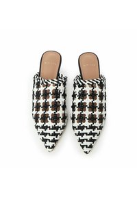 Pointed-toe mules made of black and white woven material with a patterned design. Features a smooth brown insole and open back.