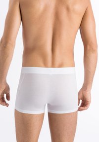Vita boxer-briefs i en mjuk, elastisk tyg. Har en bred, mjuk midja och en figursydd design.