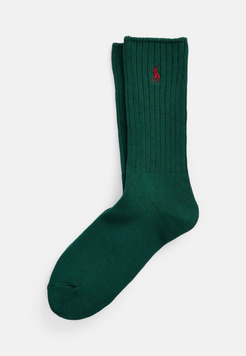 Green ribbed socks made of soft fabric, featuring a small red logo accent. The design includes a reinforced toe and cuff for durability.