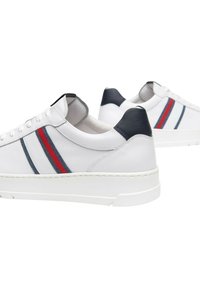 Sneakers bianchi in pelle con un accento blu marine sul tallone, caratterizzati da dettagli a strisce rosse e blu lungo il lato e una suola in gomma bianca.