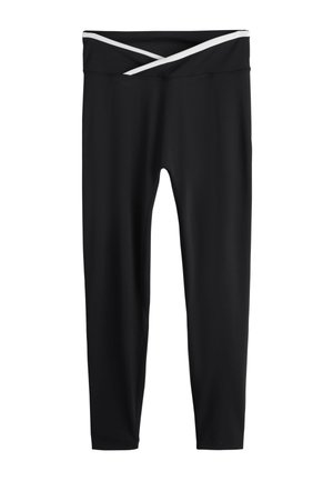Mustat täyspitkät leggingsit, joissa on ristikkäinen valkoinen vyötärönauha, suunniteltu urheilulliseen tai rentoon käyttöön.