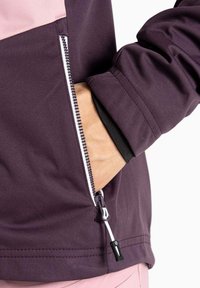 Lila Jacke mit einem pinken Einsatz, ausgestattet mit einer Reißverschlusstasche und elastischen Bündchen. Der Stoff wirkt glatt und wasserabweisend.