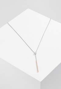 Sleek silver necklace with a cylindrical rose gold accent, featuring a thin chain and a sliding closure for adjustable length.