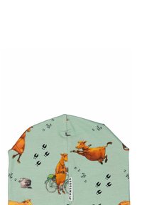 Mint-vihreä pipo, joka on valmistettu pehmeästä kankaasta ja jossa on leikkisiä lehmäkuvia, pyöräkuvioita ja erottuvia kaviojälkiä mustana.