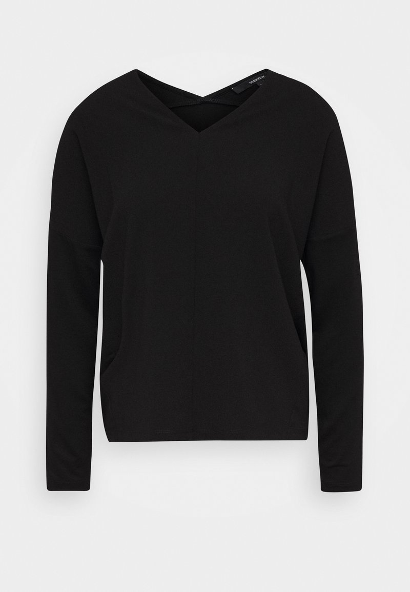 Svart långärmad topp med V-ringning och korsdetalj. Tillverkad av mjukt tyg, med en avslappnad passform och sidofickor.