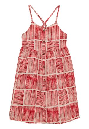 Robe mi-longue sans manches avec fines bretelles croisées, boutons à l'avant et motif géométrique rouge sur fond clair.