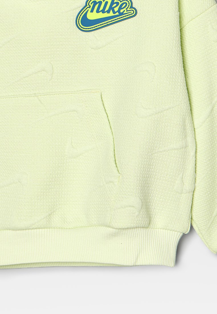 Haut à capuche vert clair en tissu texturé, comportant une poche kangourou et un logo Nike bleu vif sur la poitrine. Poignets et ourlet côtelés.