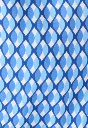 Katoenstof met een geometrisch patroon van in elkaar grijpende licht- en donkerblauwe ovalen op een witte achtergrond.