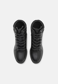 Black leather mid-calf boots with round toe, flat sole, and lace-up design. Smooth texture with padded collar and ankle support.