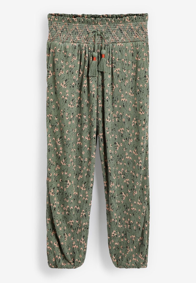 Pantalon ample à motif floral vert avec taille smockée élastique, cordon ajustable avec pompons et poignets élastiqués.