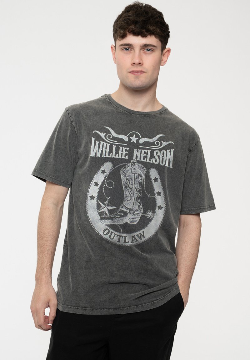 Gray cotton t-shirt featuring a cowboy boot graphic, "Willie Nelson" text, and "Outlaw" banner. Short sleeves and a crew neckline.