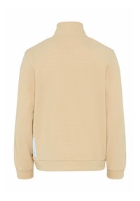 Felpa beige con zip e colletto alto, polsini e orlo a costine. Texture liscia, design minimal, con un piccolo etichetta sul lato.