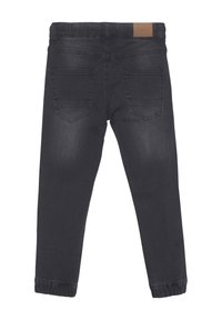 Schwarze Jeans aus Denim mit schmal zulaufendem Schnitt, mittelhoher Taille, Gesäßtaschen und elastischen Bündchen an den Knöcheln für einen engen Abschluss.