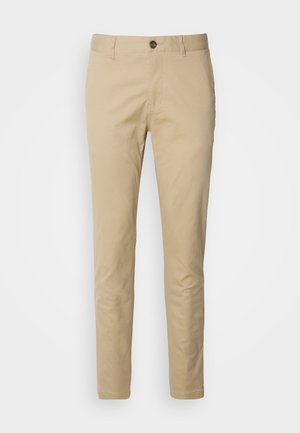 Beige Chinos mit Knopfverschluss, slim fit und glattem Baumwollstoff. Mit Steppnähten und klassischem Fünf-Taschen-Design.