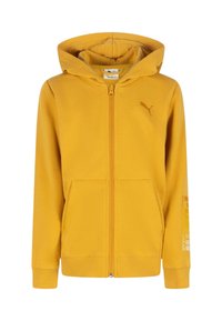 Felpa gialla con zip realizzata in tessuto morbido. Presenta un grande cappuccio, tasche frontali e un piccolo logo sul petto con testo sulla manica.