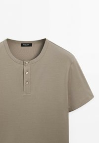 Short-sleeve beige Henley shirt with three buttons and a round neckline, label reads Massimo Dutti.
