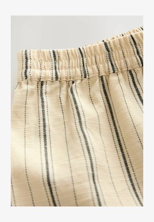 Gestreifter Stoff in hellbeige mit feinen schwarzen Linien. Verfügt über einen elastischen Bund und eine weiche, strukturierte Oberfläche.