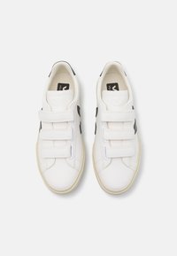 Hvite sneakers med tre borrelåser, svarte accenter på sidene, gummisåle, glatt tekstur og et minimalistisk design.