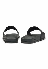 Black slide sandals with a textured footbed, wide straps, and a rubber sole. Minimalist design with no additional accents or patterns.