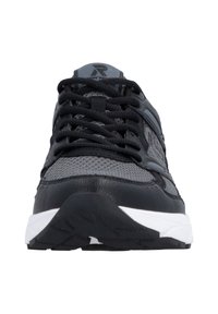 Black and gray sneaker with mesh and leather materials, featuring a textured surface, white sole, and standard lacing system.
