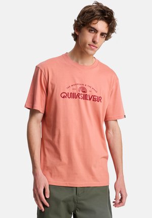 Jasnoróżowa bawełniana koszulka z krótkimi rękawami i okrągłym dekoltem. Z przodu znajduje się ciemnoczerwony graficzny logo i tekst.